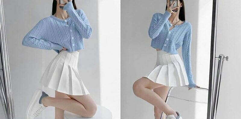 Phối đồ năng động với áo len và chân váy trắng.